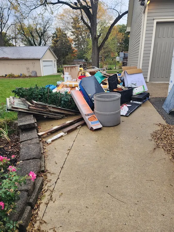 Dumpster being loaded with debris for Roofing Dumpster Rental in Prattville